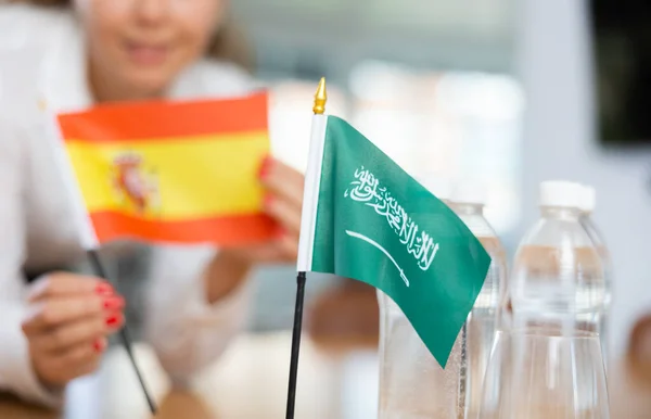 Preparing Business Negotiations Woman Sets Small Flags Countries Saudi Arabia — Stock Photo, Image