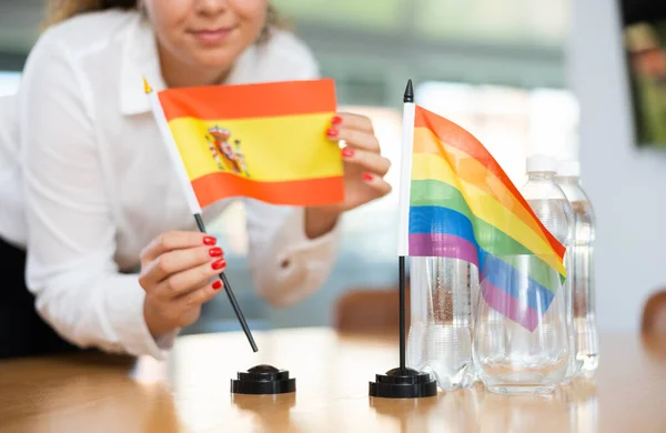 Young Woman Business Clothes Puts Flags Spain Lgbt Negotiating Table — Stock Photo, Image
