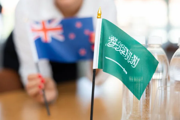 安排沙特阿拉伯和澳大利亚国旗进行演示和谈判的女商人 — 图库照片