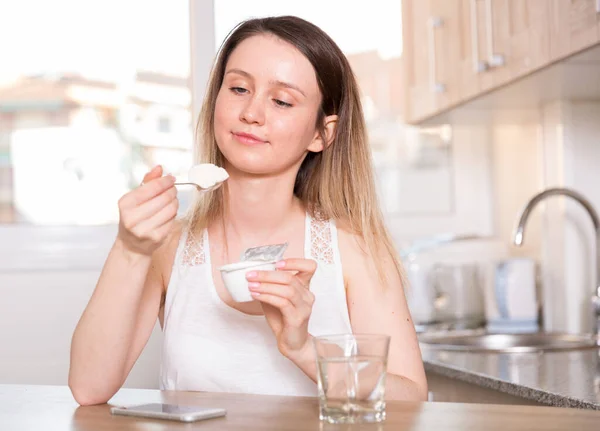 Sporty Girl Sitting Table Eating Yogurt Home —  Fotos de Stock