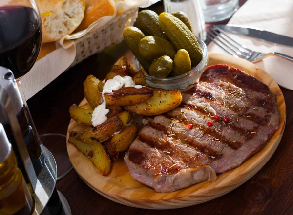 Chutný Hovězí Steak Podávaný Okurkami Bramborovými Klíny Dřevěném Podnose — Stock fotografie