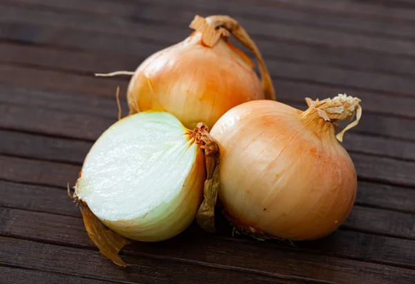 stock image Agricultural production, fresh raw bulbs onion on wooden table