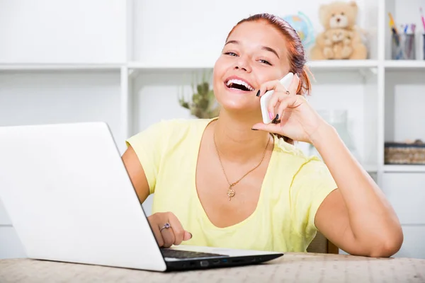 Joyful Smiling Female Teenager Student Chatting Phone Typing Computer Indoors — Stock Photo, Image