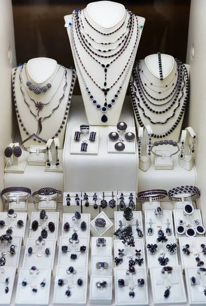 宝石店のディスプレイ上の様々な自然の貴重なチェコのガーネット石の宝石類 — ストック写真