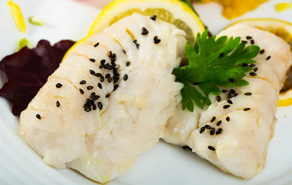 stock image Dietary merluccid hake fillets steamed, served with lemon and greens..