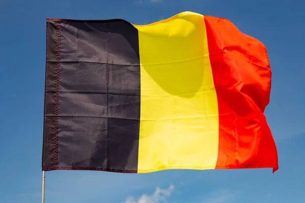 青空にベルギーの旗を掲げる — ストック写真