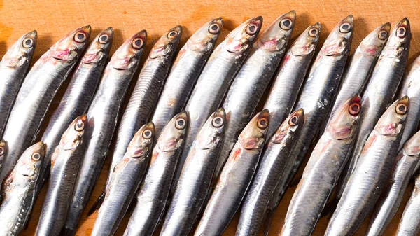 Lot Fresh Raw Anchovies Fishes Wooden Surface — Foto Stock