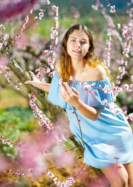 Positive European Girl Blue Dress Standing Blossom Peach Tree Sunny — Stock Photo, Image