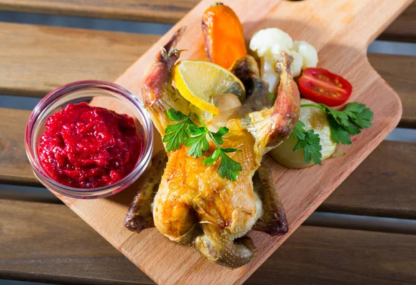 Poultry dish baked in oven exquisitely served with cranberry sauce and grilled vegetables