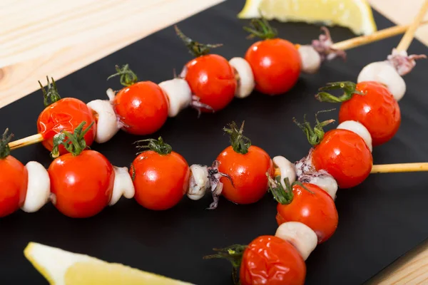Baked Mini Calamari Cherry Tomatoes Skewers Serving Black Board Lemon — Stock Photo, Image