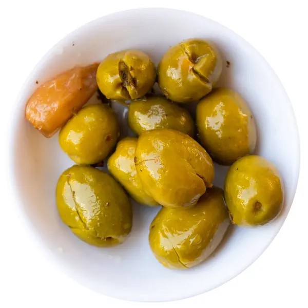 Light and nutritious snack awaits, consisting of handful of pickled green pitted olives and slice of wholesome bran bread.. Isolated over white background