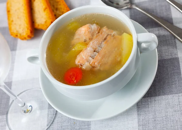 Fish soup with salmon bones and head, potato and carrot