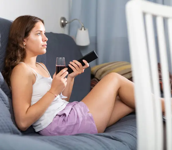Positive Young Woman Sitting Couch Home Holding Remote Glass Red — Stock Photo, Image