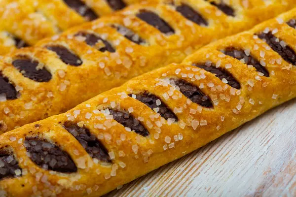 stock image Closeup of sweet chocolate tronquito - crispy puff pastry with chocolate filling sprinkled with sugar