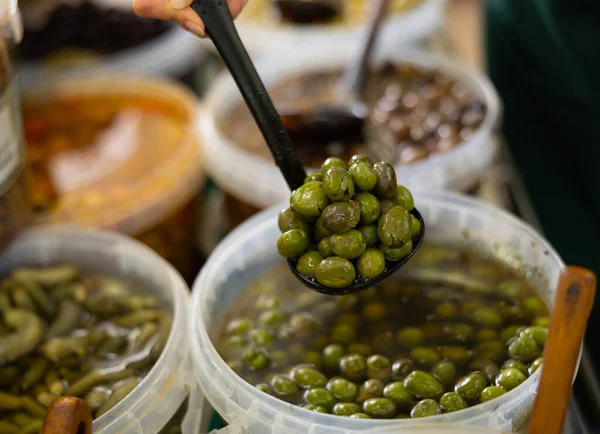 Plastic Container Full Pickled Olives Held Skimmer Stall Alongside Other — Stock Photo, Image