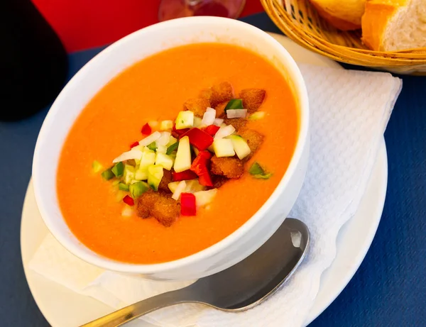 Image of spanish traditional cold soup gazpacho in bowl with tomatoes and cucumber..