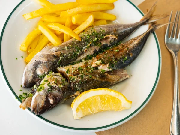 Grill pub and fish restaurant menu, grilled mackerel with lemon, herbs and potatoes