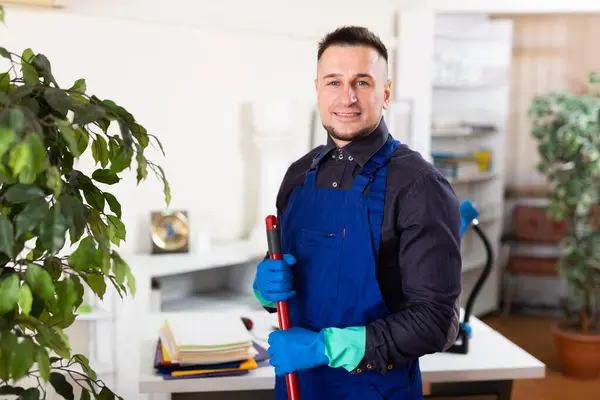 Male Professional Janitor Dusting Modern Office Interior — Stock Photo, Image