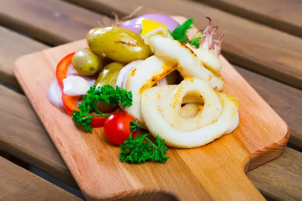 Delicious Baked Squid Rings Potatoes Fresh Vegetables Herbs Served Wooden — Stock Photo, Image