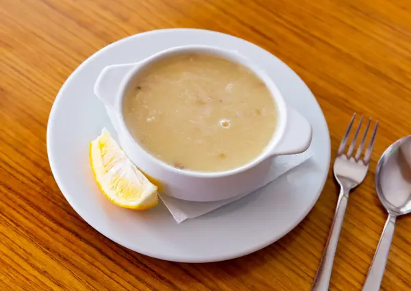 stock image Homemade turkish soup Tavuk Suyu corbasi in a white ceramic soup plate