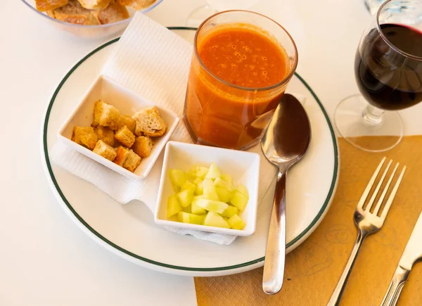 Traditional Spanish dish Gazpacho, made from tomato puree, is served with croutons and sliced cucumber