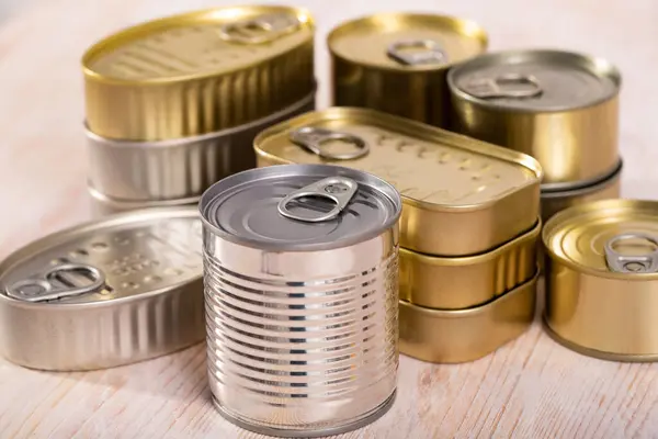 Close up of golden and silver tin cans