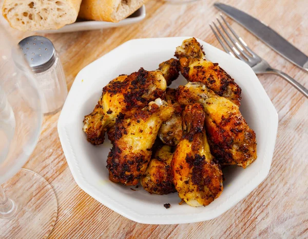 Plate of tasty snack - roasted chicken wings with flavoring