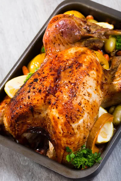 Baked turkey. Rub turkey with salt, pepper, provencal herbs, honey and balsamic. Covered with foil turkey cook in oven 2 hours at 180 g. Take off foil, put apples, vegetables and cook 40 minutes.