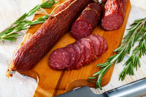 Appetizing Russian Dry Smoked Pork Sausage Rosemary Wooden Background — Stock Photo, Image