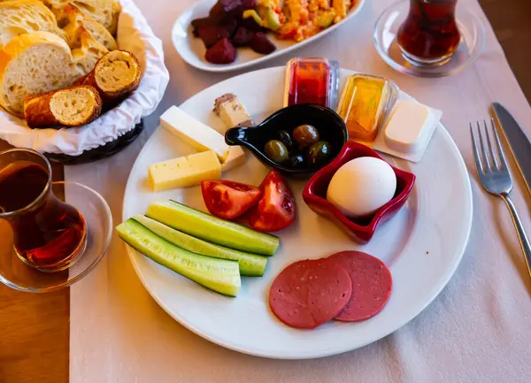 Halal breakfast at the hotel of boiled eggs, smoked sausage, chopped vegetables, cheese, olives, sauce and ..salad with bread...