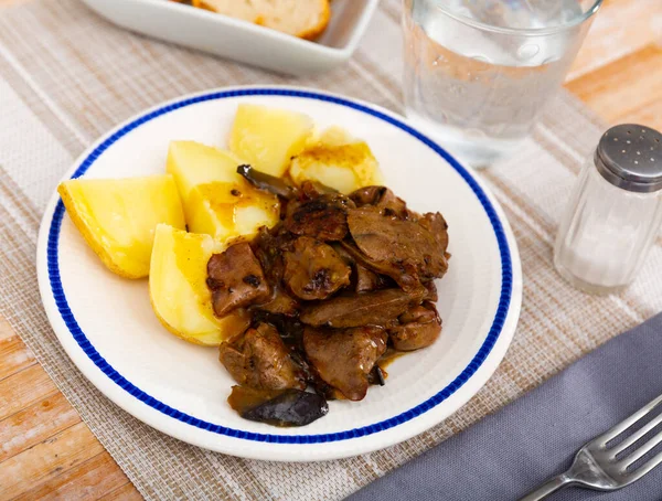Stir fried rabbit liver with onion served with boiled potato