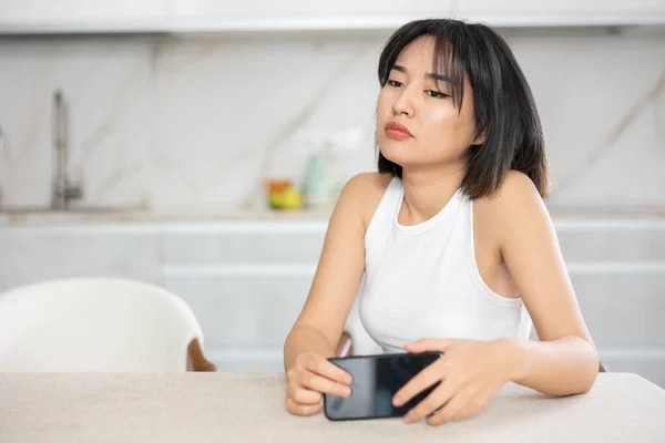 Upset Young Asian Woman Sitting Melancholic Pose Holding Mobile Phone — Stock Photo, Image