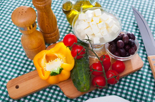 Cooking Greek salad with mozzarella cheese. Ingredients on the table. High quality photo