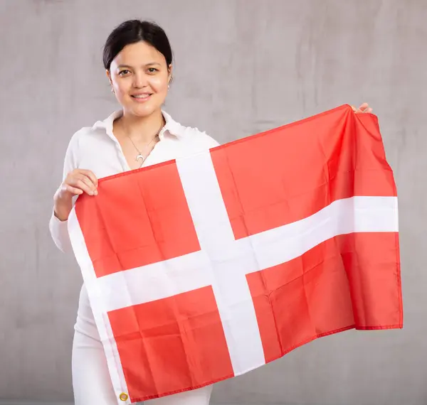 Portret Młodej Uśmiechniętej Kobiety Luźnych Ubraniach Pozujących Flagą Danii Studio — Zdjęcie stockowe