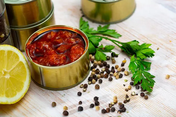 stock image Canned squid in sauce served on table