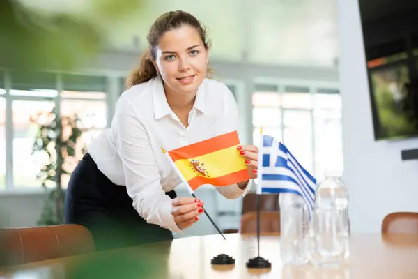 Young Female Assistant Setting Greek Spanish Flags International Negotiations — Stock Photo, Image
