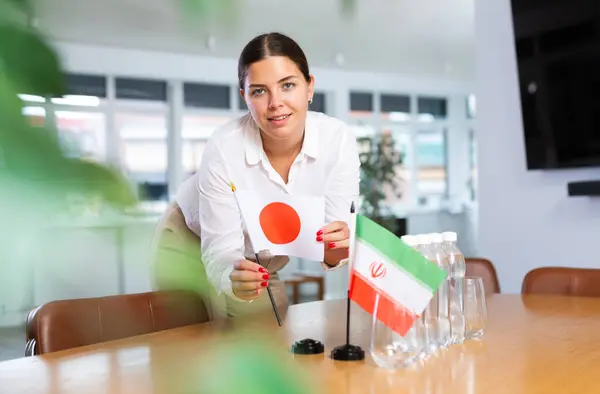 stock image Secretary shows the flags of Japan and Iran on the table. Preparing for a meeting, negotiations.