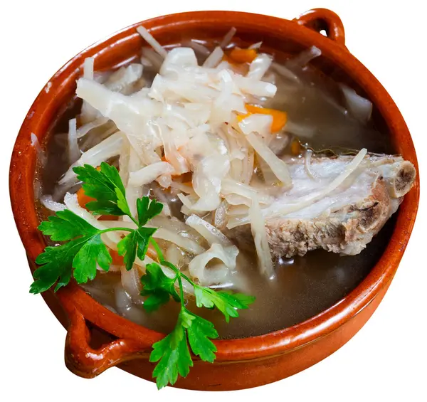 Freshly prepared hearty lunch - fragrant cabbage soup with potato, carrot and pork ribs. Isolated over white background