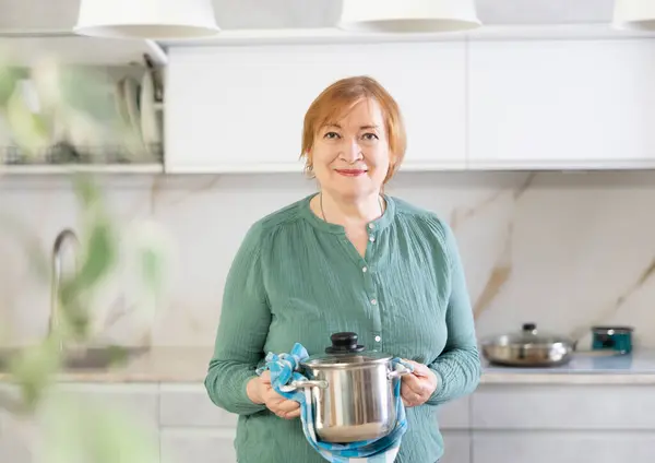 Mature Woman Stands Modern Home Kitchen Holds Stainless Utensil Hands — Stock Photo, Image
