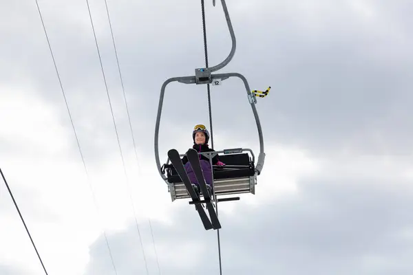 Smiling Young Woman Ski Outfit Sitting Alone Chairlift Raising Slopes — Stock Photo, Image