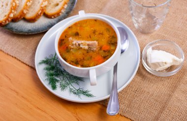 Traditional Russian soup rassolnik made from pickled cucumbers, pearl barley, and beef kidneys. High quality photo clipart