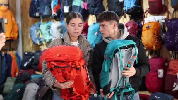 Young Married Couple Winter Clothes Chooses Durable Backpack Winter Hike — Stock Video