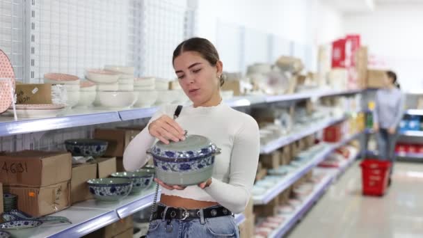 Junge Shopperin Wählt Mit Interesse Orientalischen Stil Porzellansuppenterrine Zwischen Verschiedenen — Stockvideo