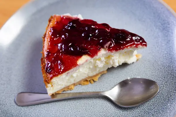 stock image Slice of classic creamy cheesecake with cranberries sauce. Popular dessert