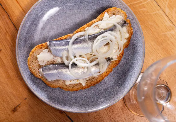Delicious toast with herring fish and butter served on platter