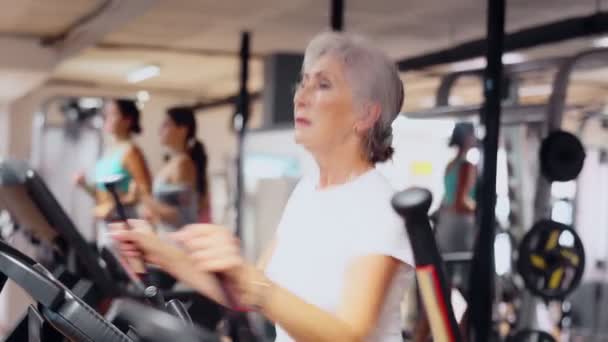 Slanke Atletische Volwassen Vrouw Tijdens Cardio Oefeningen Elliptische Simulator Fitnesscentrum — Stockvideo