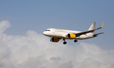 BARCELONA, SPAIN - JANUARY 23, 2020: View of Vueling Airlines EC-NAZ Airbus A320 during final approaching to runway at El Prat Airport .. clipart