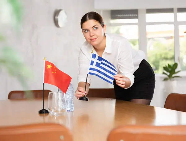 Young Woman Setting Flags Table International Negotiations China Greece — Stock Photo, Image