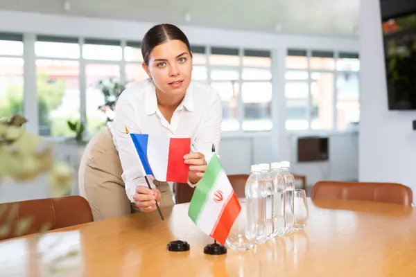 Positive Young Woman Putting Little Flag France Table Next Flag — Stock Photo, Image