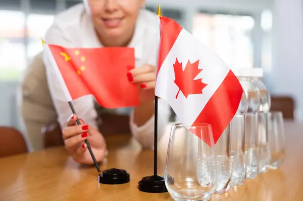 Young Woman Business Clothes Puts Flags China Canada Negotiating Table — Stock Photo, Image